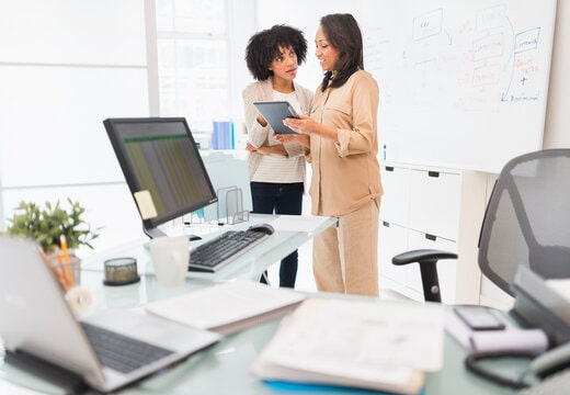 Two women discussing equity-centered approach to leadership